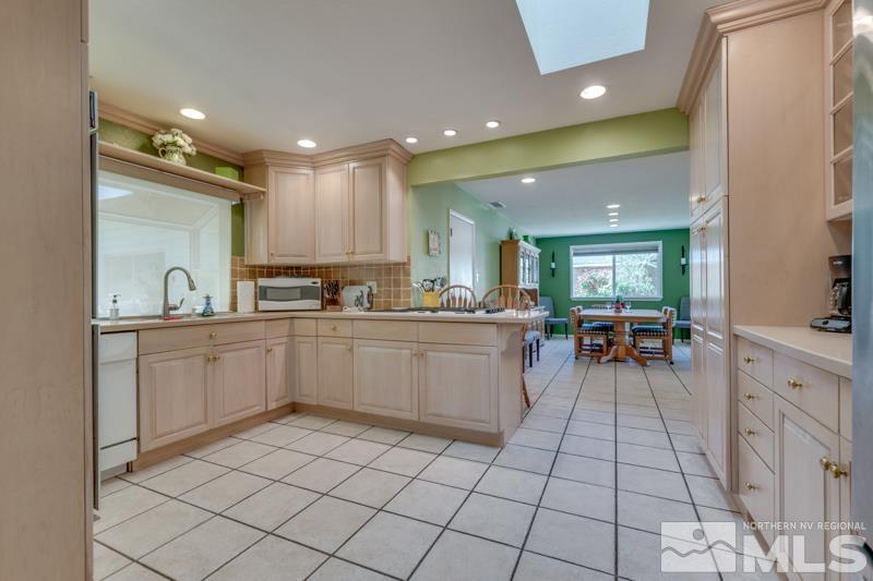 1870 Watt Street Reno, NV 89509 - Photo 7 of 26 a kitchen with a sink a counter top space and stainless steel appliances