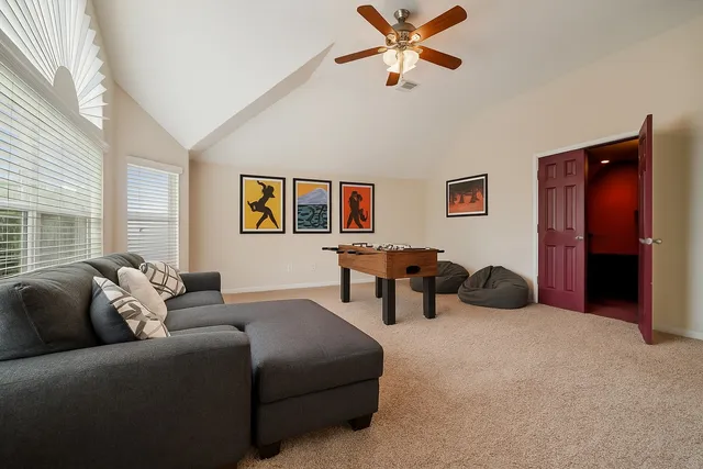 a living room with furniture and a chandelier
