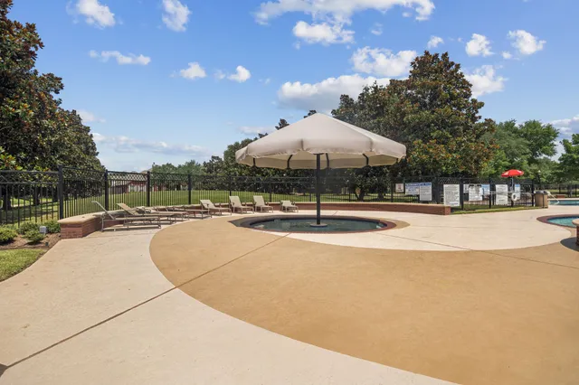 a swimming pool with outdoor seating and yard in the back