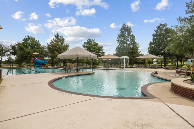 a view of a swimming pool with a patio