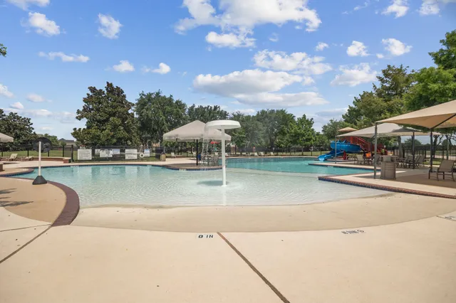 a view of a swimming pool with a patio