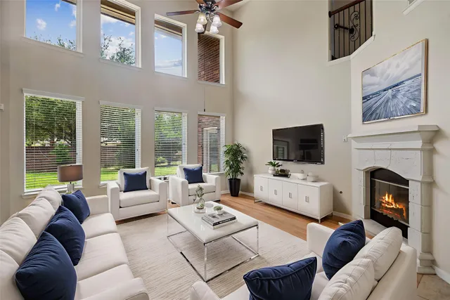 a living room with furniture fireplace and flat screen tv