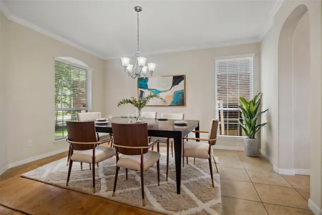 a view of a dining room with furniture and chandelier