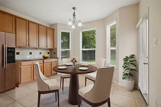 a dining room with furniture potted plants and wooden floor