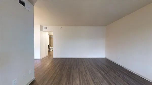 a view of a room with wooden floor