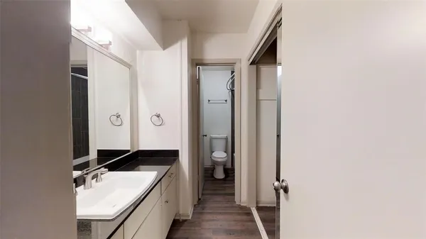 a bathroom with a granite countertop sink and a mirror