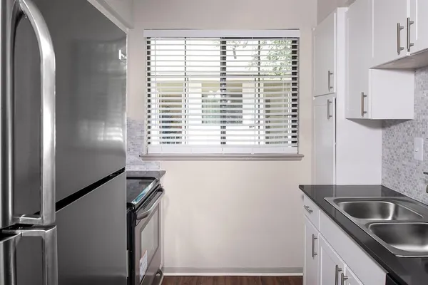 a kitchen with a window a sink and a refrigerator