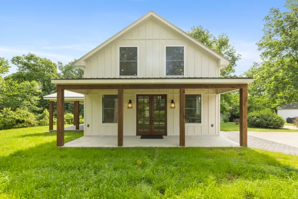 a view of a house with yard and front view of a house