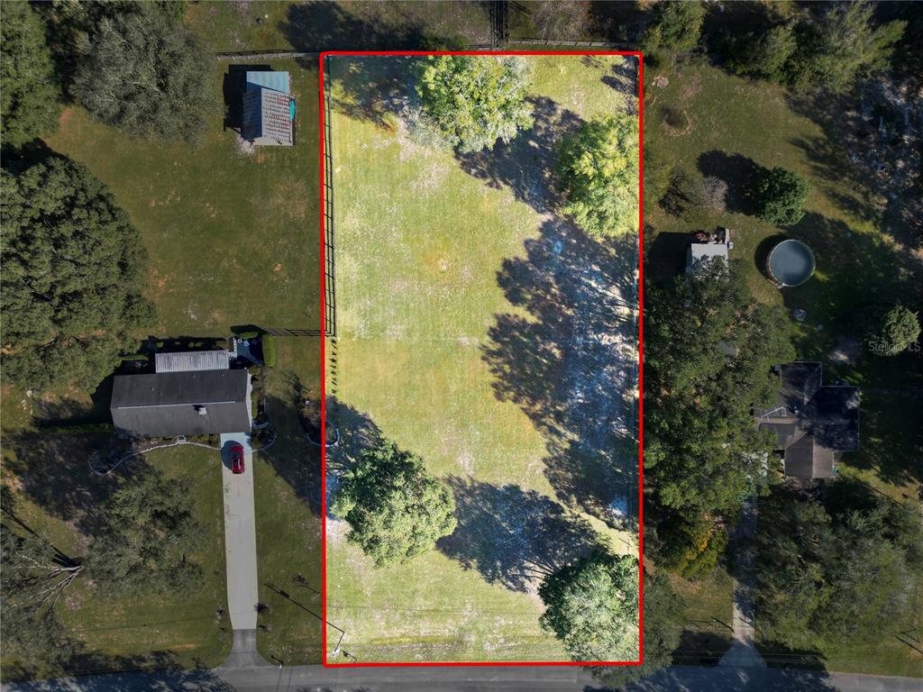 2975 Southeast 159th Lane Road Summerfield, FL 34491 - Photo 6 of 6 an aerial view of a residential houses with outdoor space