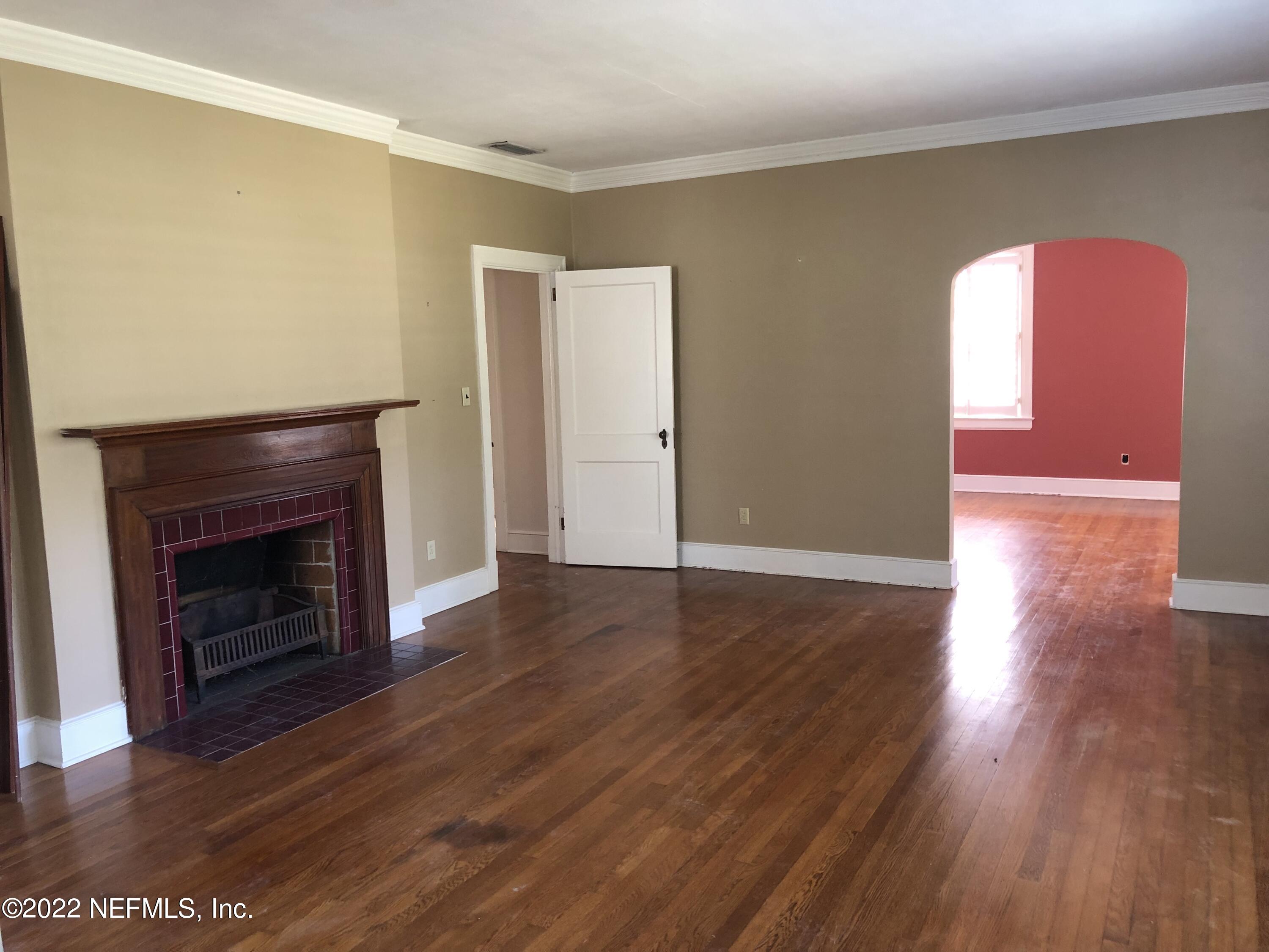 1237 Greenridge Road Jacksonville, FL 32207 - Photo 7 of 9 a view of a livingroom with wooden floor and a fireplace
