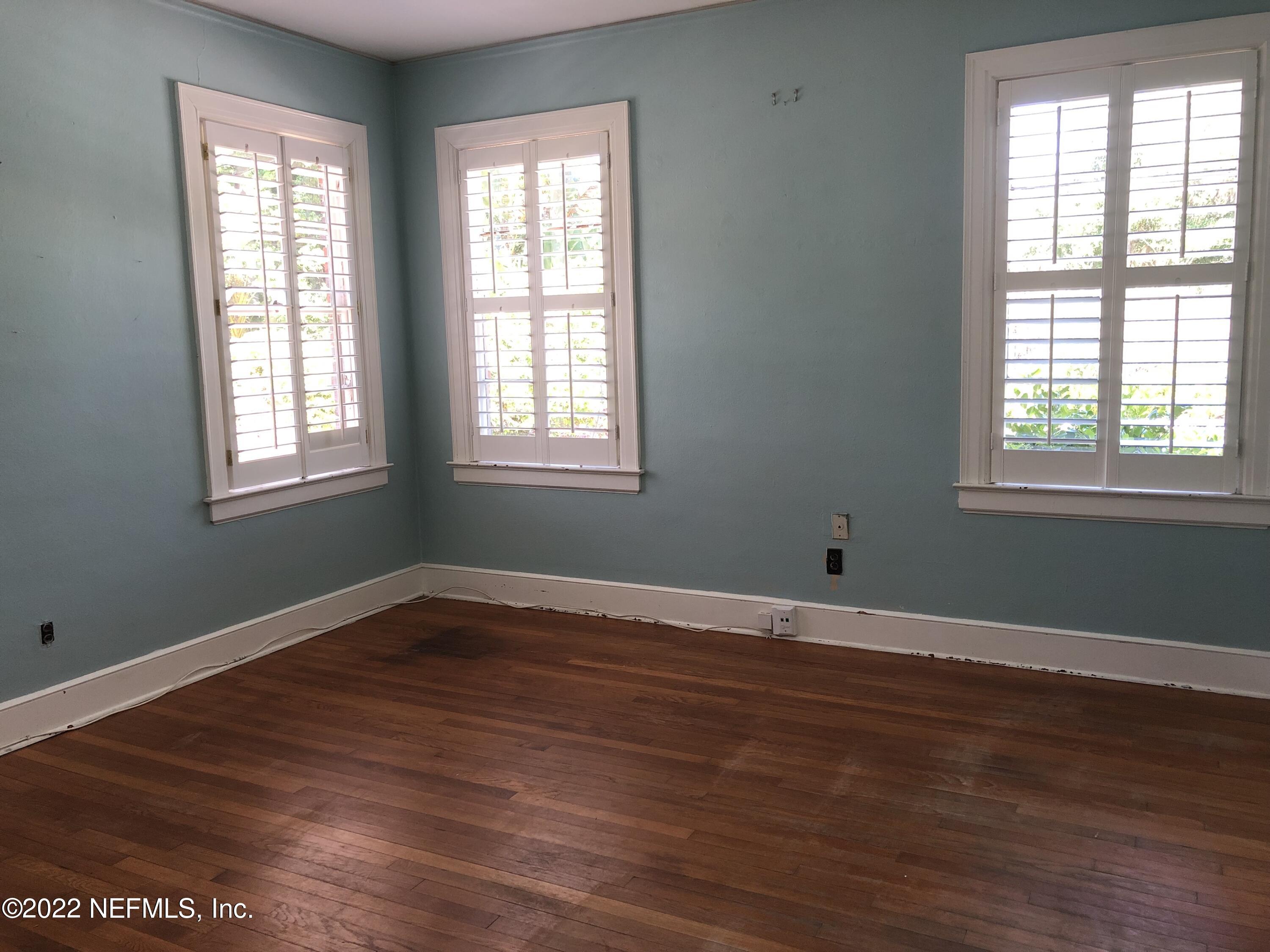 1237 Greenridge Road Jacksonville, FL 32207 - Photo 8 of 9 a view of an empty room with wooden floor and a window