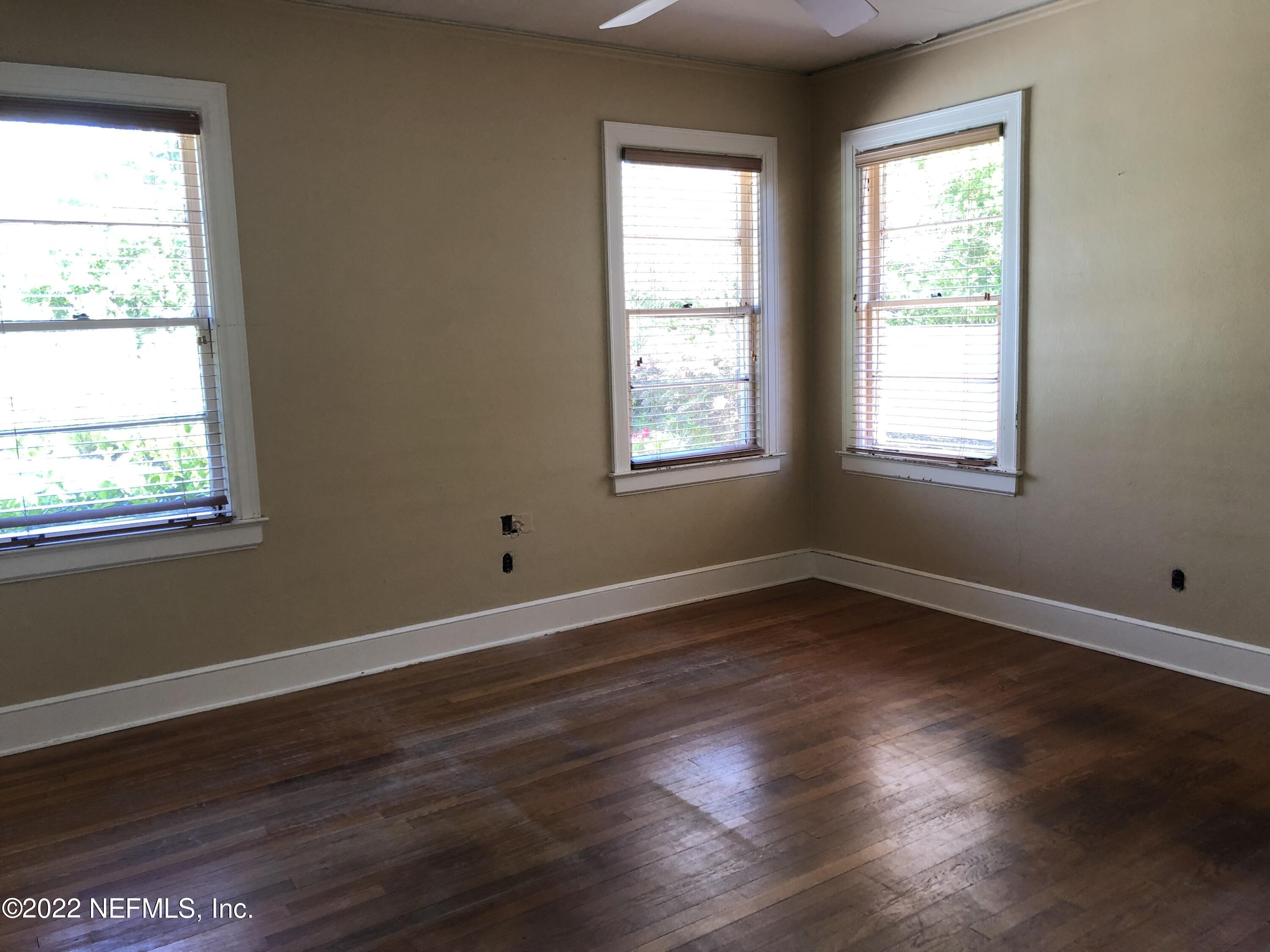1237 Greenridge Road Jacksonville, FL 32207 - Photo 9 of 9 a view of an empty room with wooden floor and a window