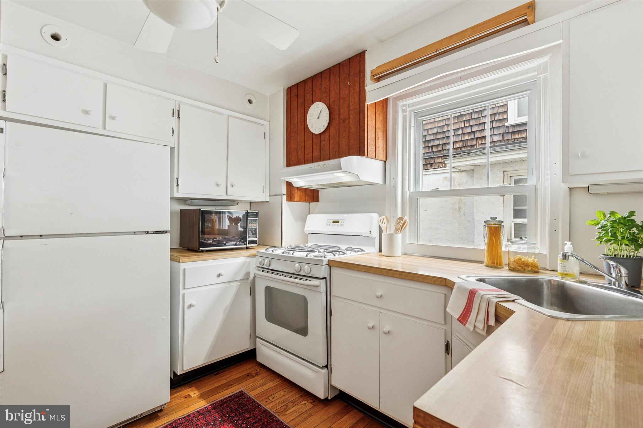 208 Sabine Avenue Narberth, PA 19072 - Photo 16 of 38 a kitchen with a sink cabinets and window