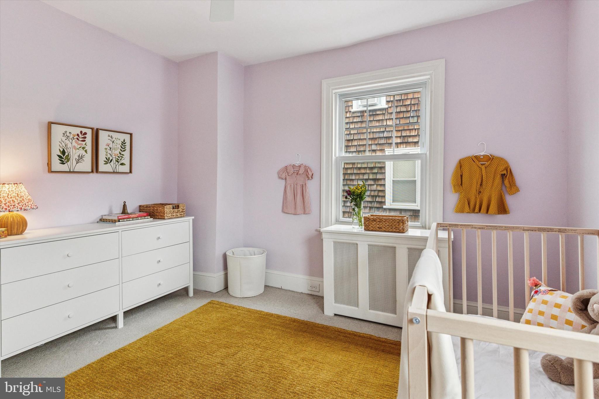 208 Sabine Avenue Narberth, PA 19072 - Photo 22 of 38 a living room with a baby crib furniture and a window