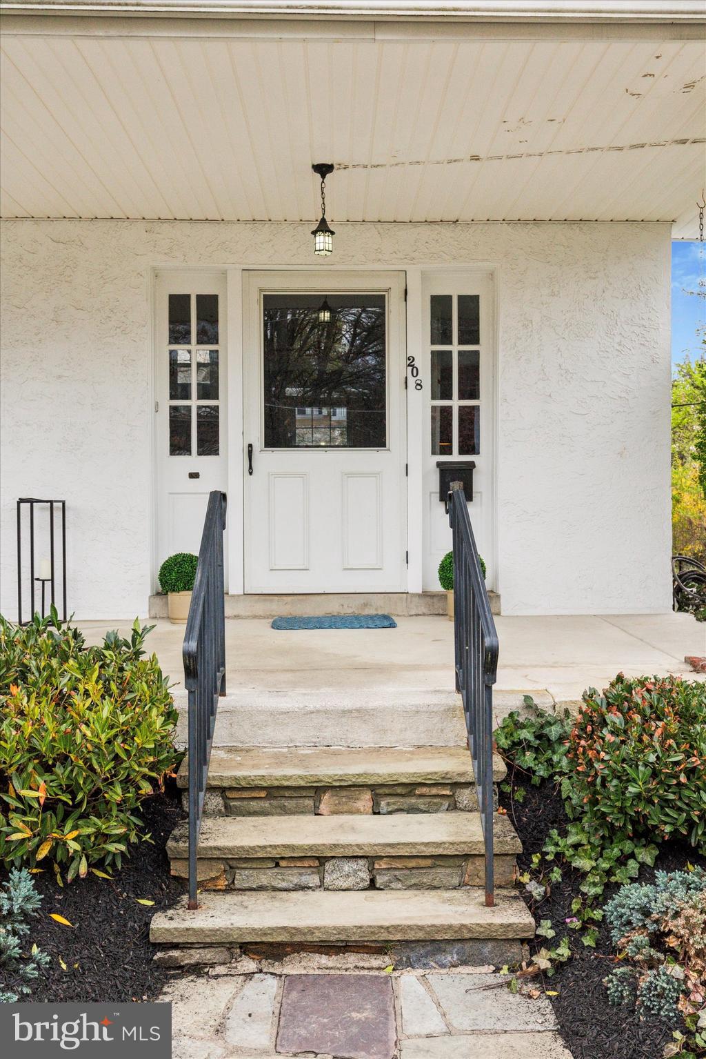 208 Sabine Avenue Narberth, PA 19072 - Photo 3 of 38 a front view of a house with potted plants