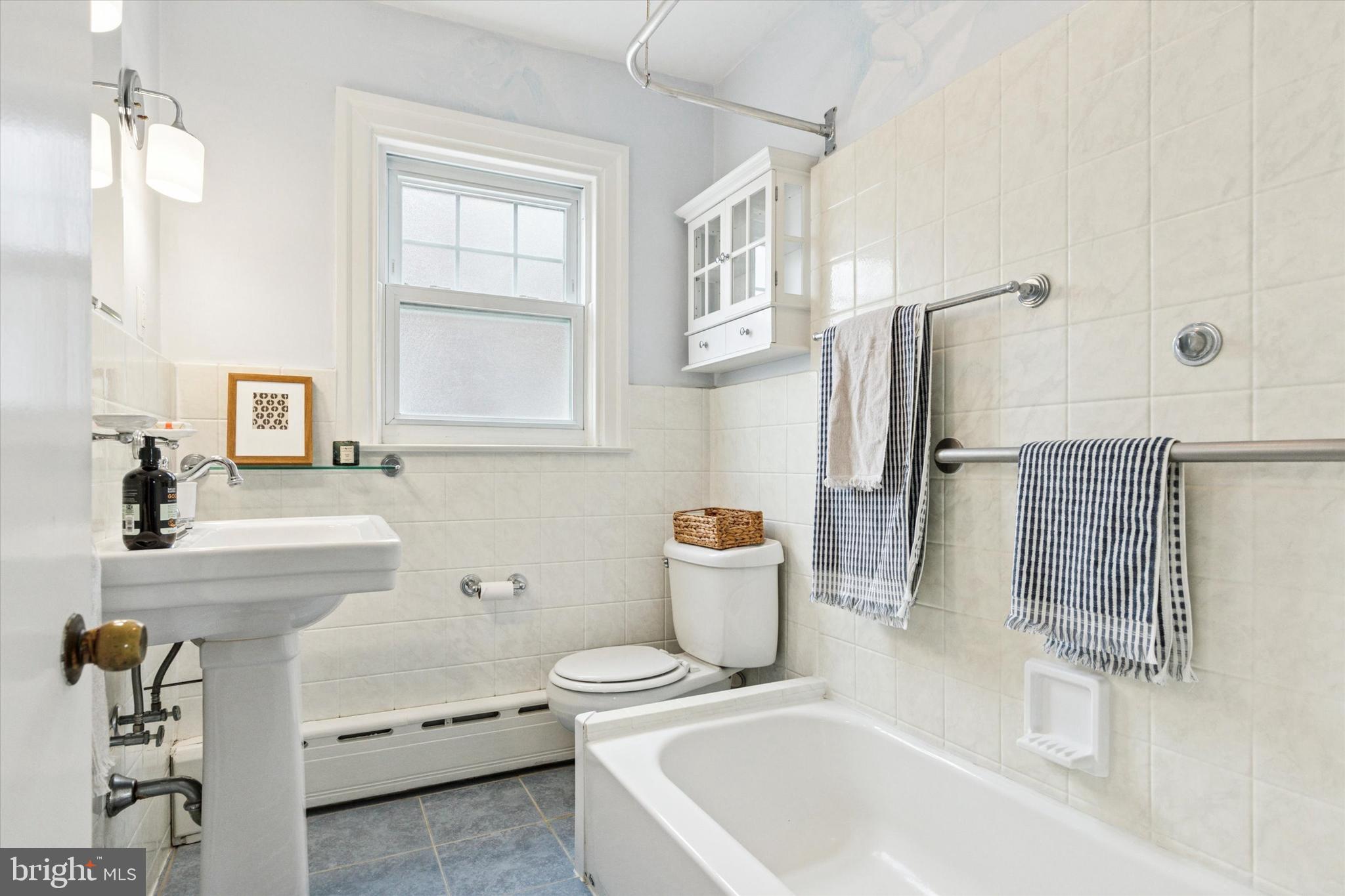 208 Sabine Avenue Narberth, PA 19072 - Photo 31 of 38 a bathroom with a sink a toilet and shower