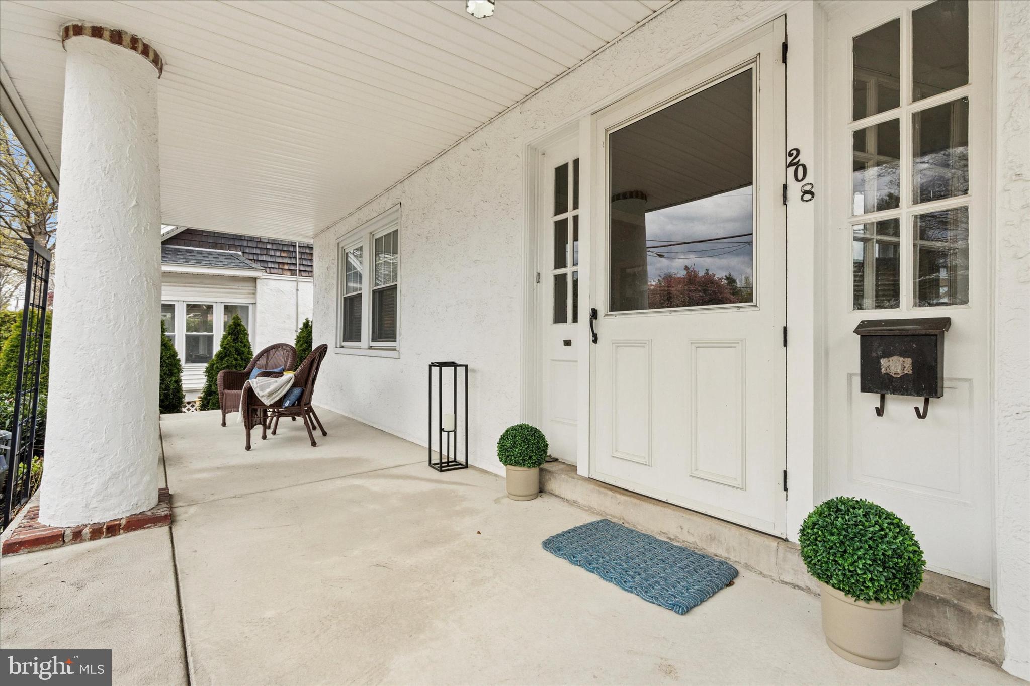 208 Sabine Avenue Narberth, PA 19072 - Photo 4 of 38 a living room with furniture and a potted plant