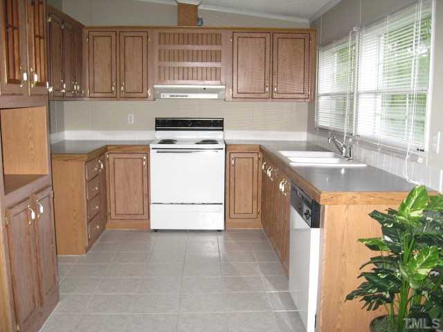 450 Al Gray Road Timberlake, NC 27583 - Photo 3 of 14 Spacious kitchen with custom cabinets & tile floor