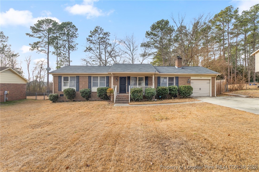 6654 Vaughn Road Fayetteville, NC 28304 - Photo 1 of 36 a front view of a house with a yard and garage