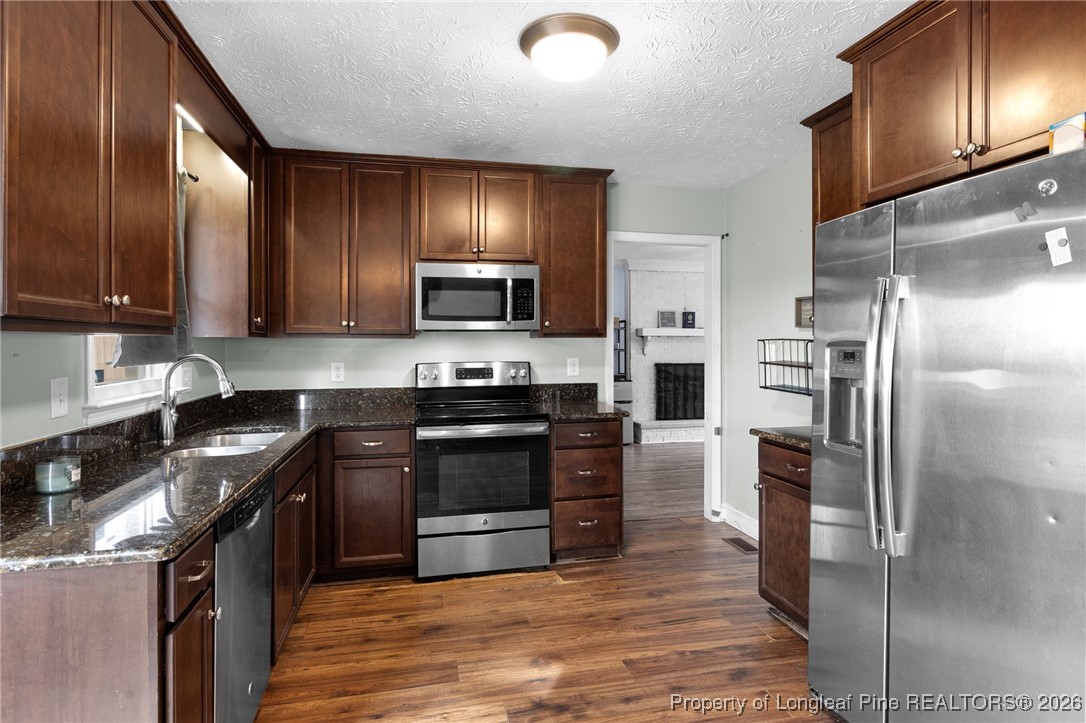 6654 Vaughn Road Fayetteville, NC 28304 - Photo 11 of 36 a kitchen with a refrigerator stove and oven