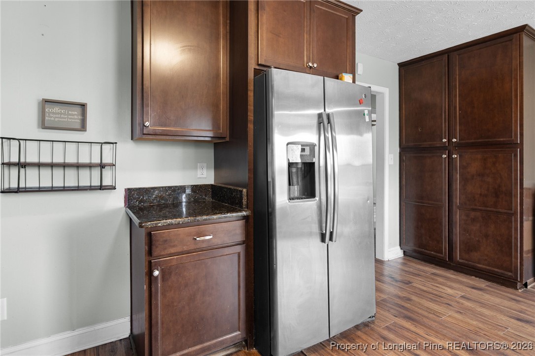 6654 Vaughn Road Fayetteville, NC 28304 - Photo 14 of 36 a kitchen with stainless steel appliances granite countertop a refrigerator and a sink