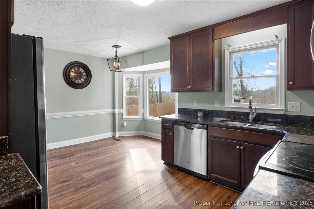 6654 Vaughn Road Fayetteville, NC 28304 - Photo 15 of 36 a kitchen with a sink and a stove top oven