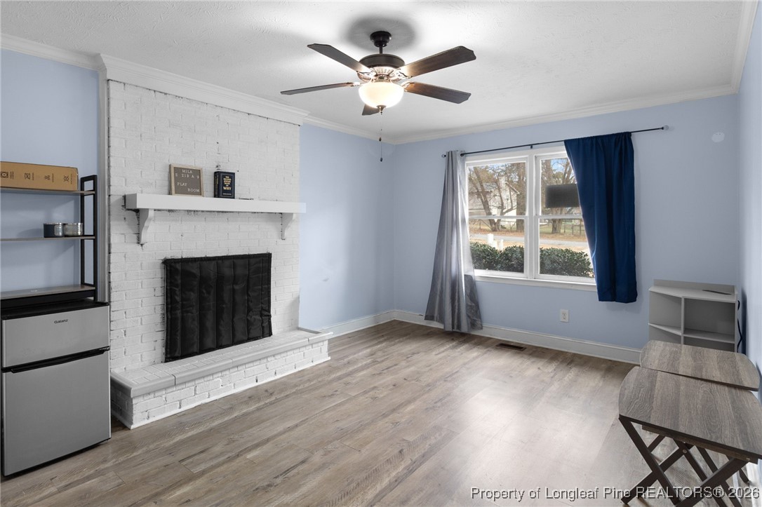 6654 Vaughn Road Fayetteville, NC 28304 - Photo 16 of 36 a view of an empty room with wooden floor and a window
