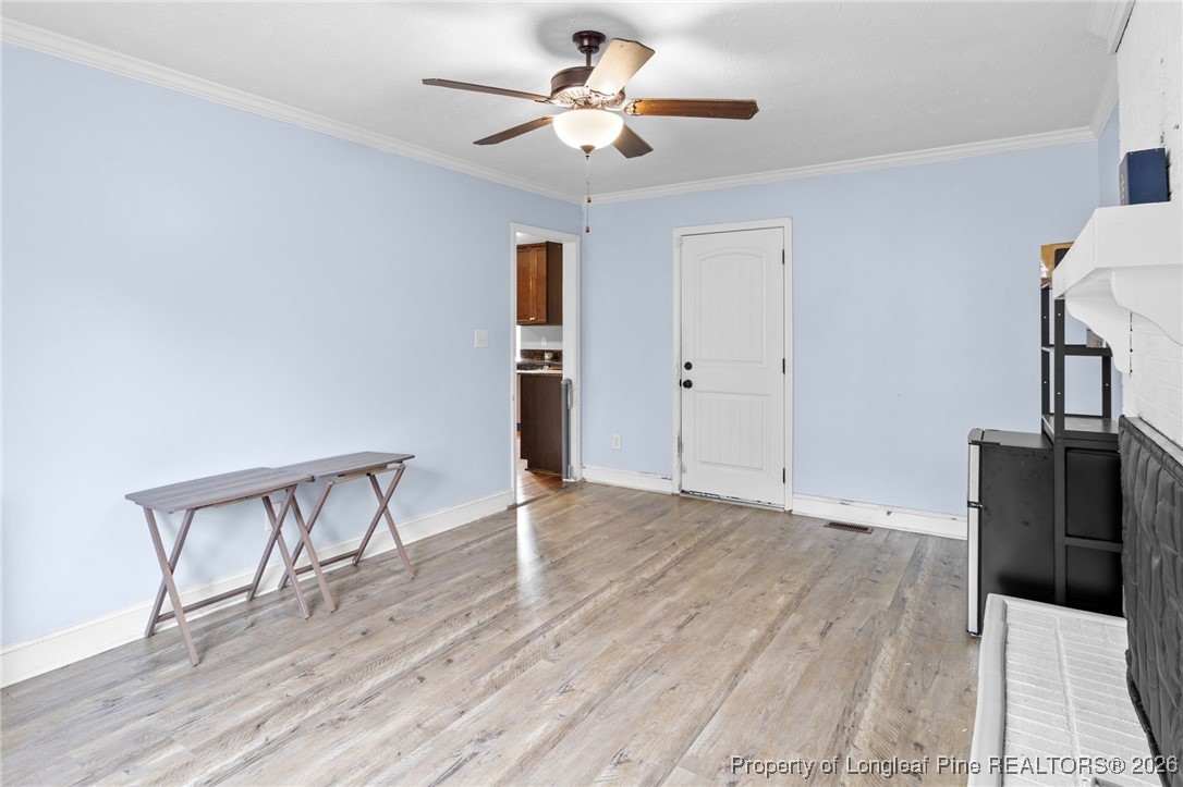 6654 Vaughn Road Fayetteville, NC 28304 - Photo 17 of 36 a view of an empty room with window and wooden floor