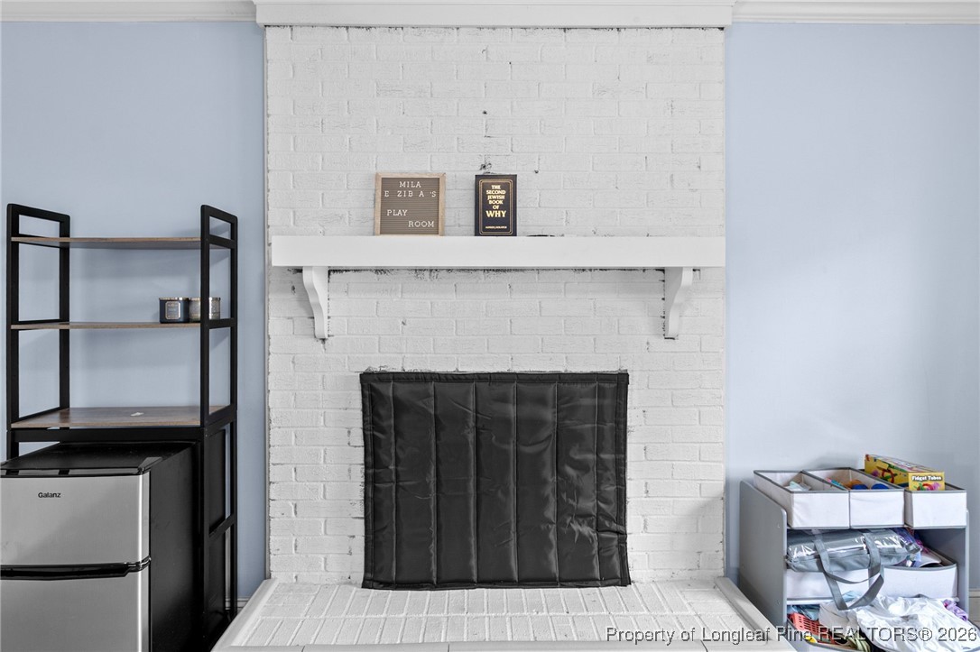 6654 Vaughn Road Fayetteville, NC 28304 - Photo 18 of 36 a living room with furniture and a fireplace