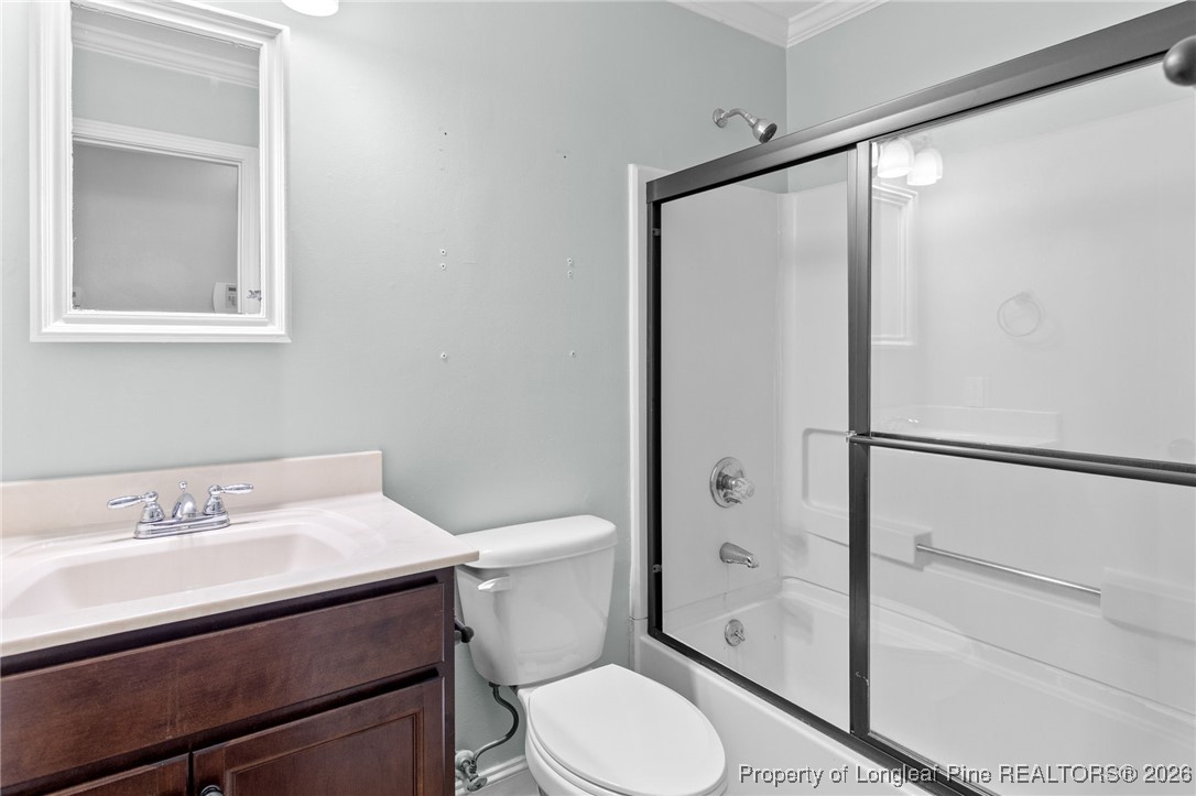 6654 Vaughn Road Fayetteville, NC 28304 - Photo 19 of 36 a bathroom with a sink toilet and shower