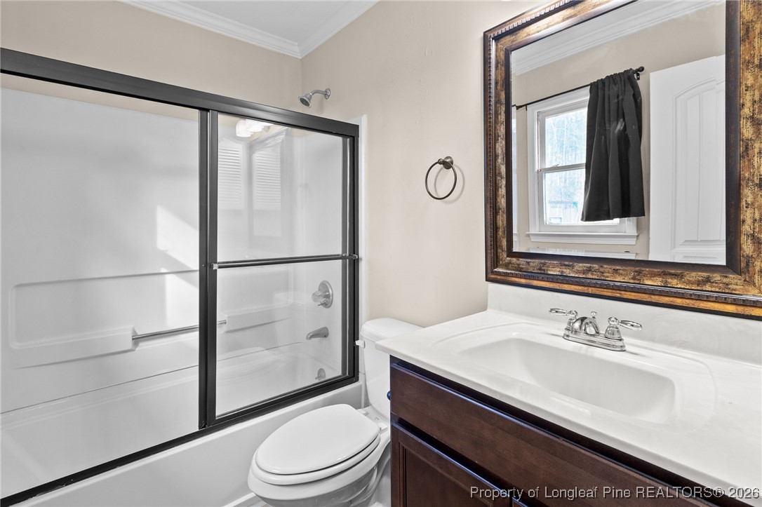 6654 Vaughn Road Fayetteville, NC 28304 - Photo 23 of 36 a bathroom with a granite countertop sink toilet and shower