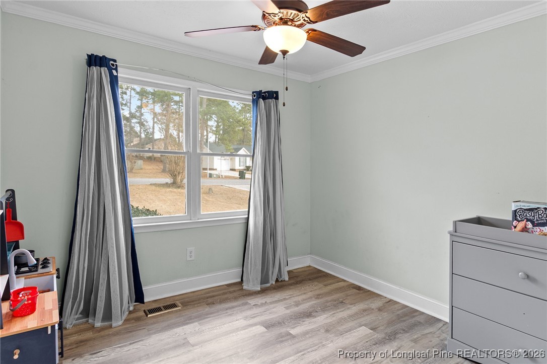 6654 Vaughn Road Fayetteville, NC 28304 - Photo 28 of 36 an empty room with ceiling fan and windows