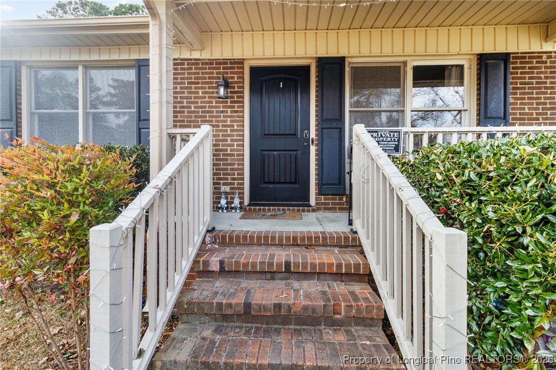 6654 Vaughn Road Fayetteville, NC 28304 - Photo 4 of 36 a view of balcony with wooden floor and stairs