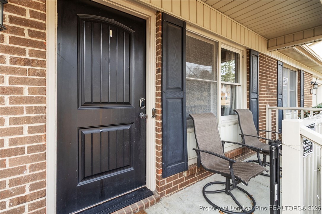 6654 Vaughn Road Fayetteville, NC 28304 - Photo 5 of 36 a view of a door and chair and table in front of house