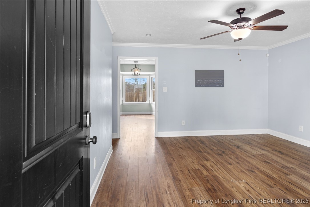 6654 Vaughn Road Fayetteville, NC 28304 - Photo 6 of 36 wooden floor in an empty room with a window