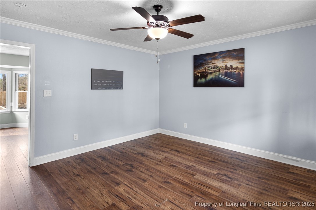 6654 Vaughn Road Fayetteville, NC 28304 - Photo 7 of 36 a view of an empty room with wooden floor