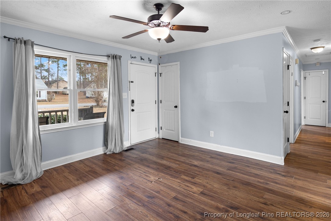 6654 Vaughn Road Fayetteville, NC 28304 - Photo 8 of 36 a view of an empty room with wooden floor and a window