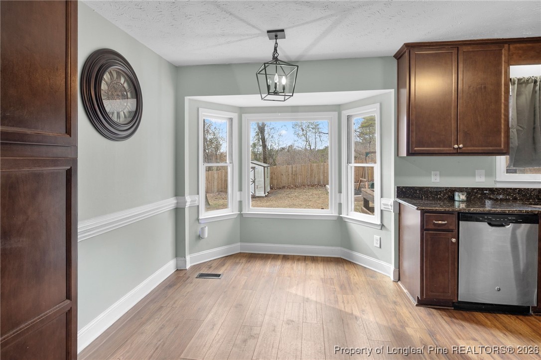 6654 Vaughn Road Fayetteville, NC 28304 - Photo 9 of 36 a view of a hallway with wooden floor and a window