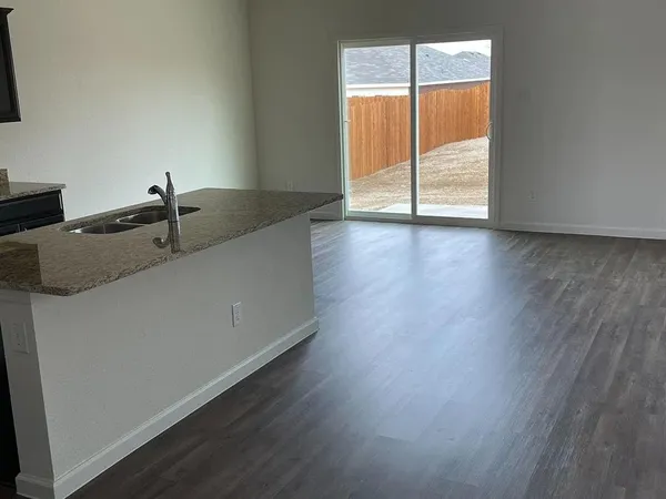 a view of a sink a window and wooden floor