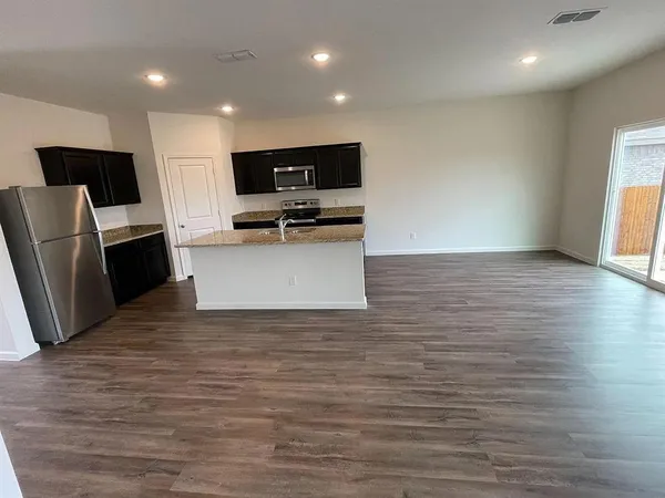 a view of kitchen with stainless steel appliances a refrigerator and a stove