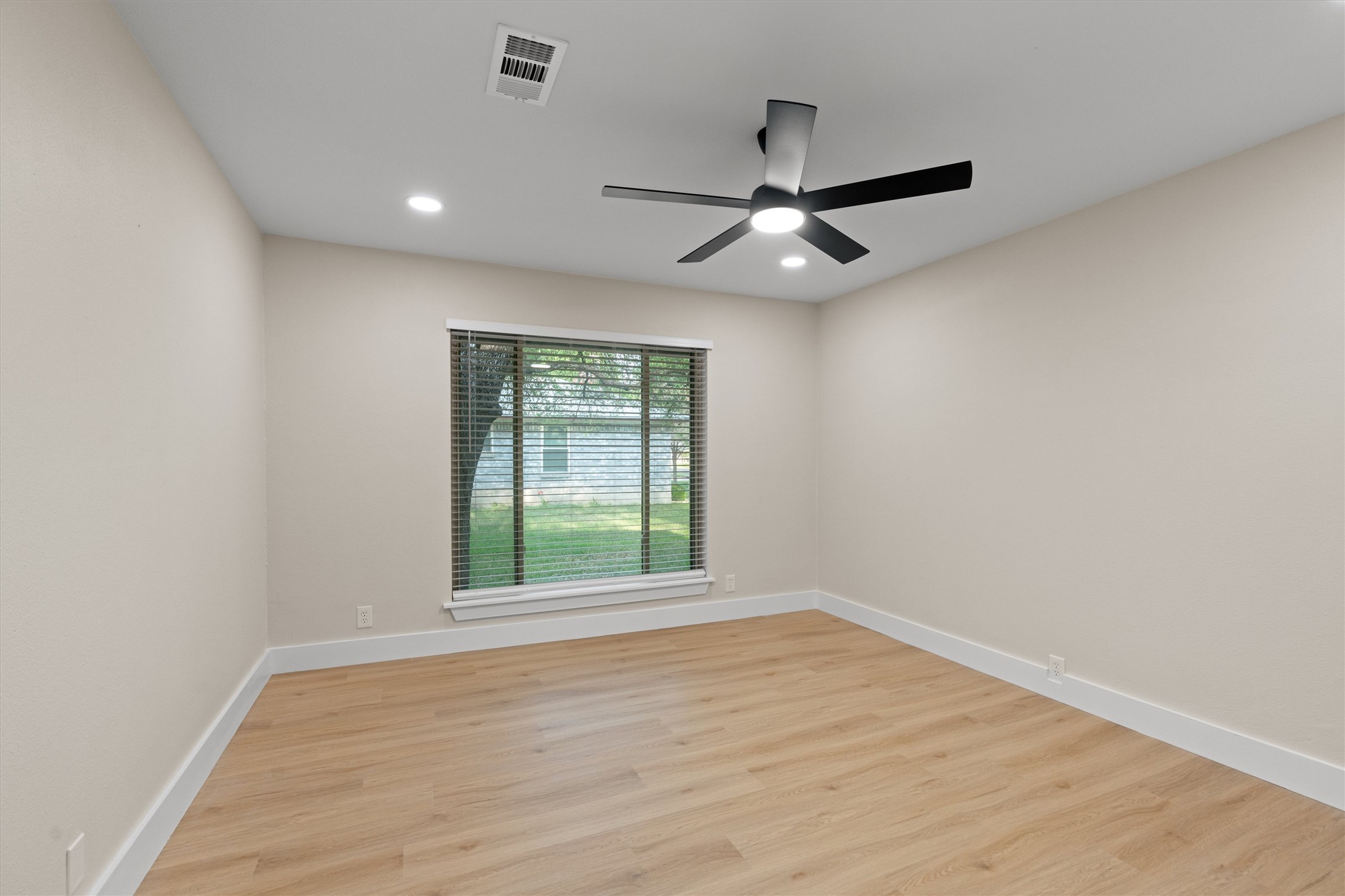 224 Clear Spring Road Georgetown, TX 78628 - Photo 28 of 40 an empty room with wooden floor fan and windows