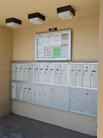 a view of house with a big yard and potted plants