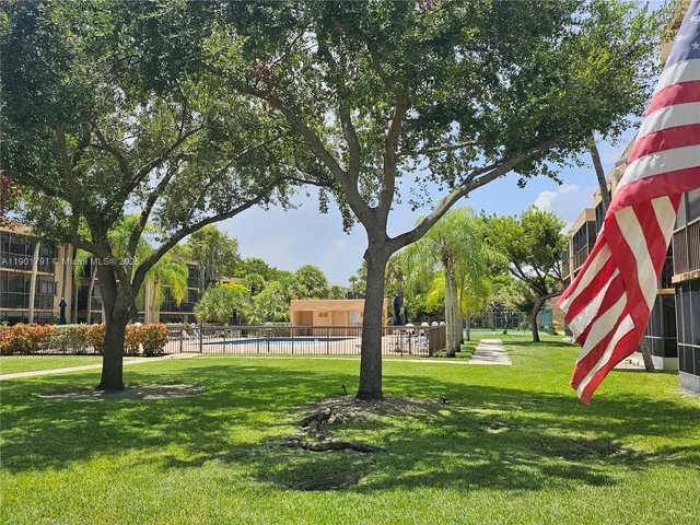 a room with pool table and windows
