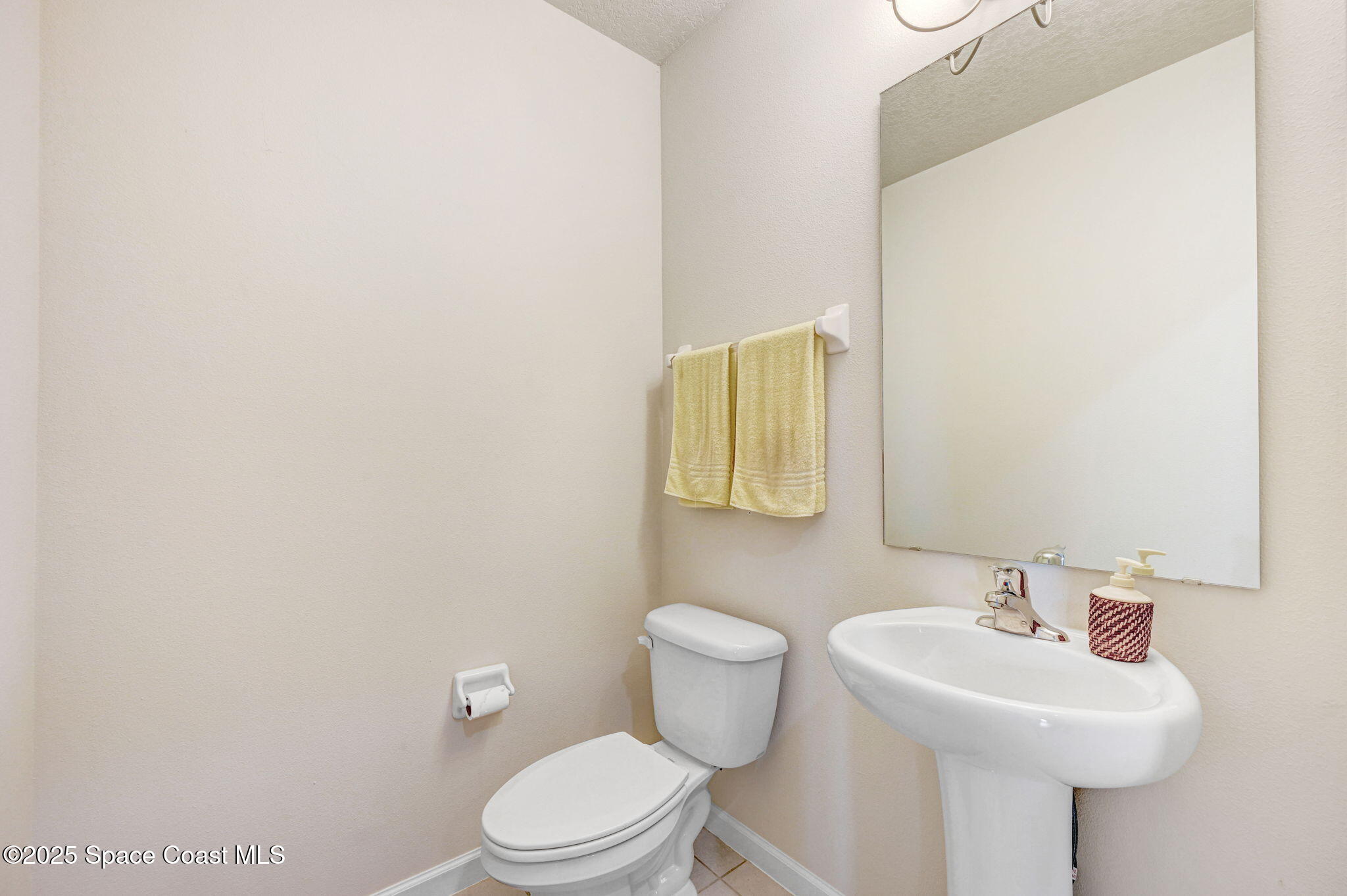 1430 Lara Circle, Unit 103 Rockledge, FL 32955 - Photo 11 of 39 a bathroom with a sink a toilet and mirror