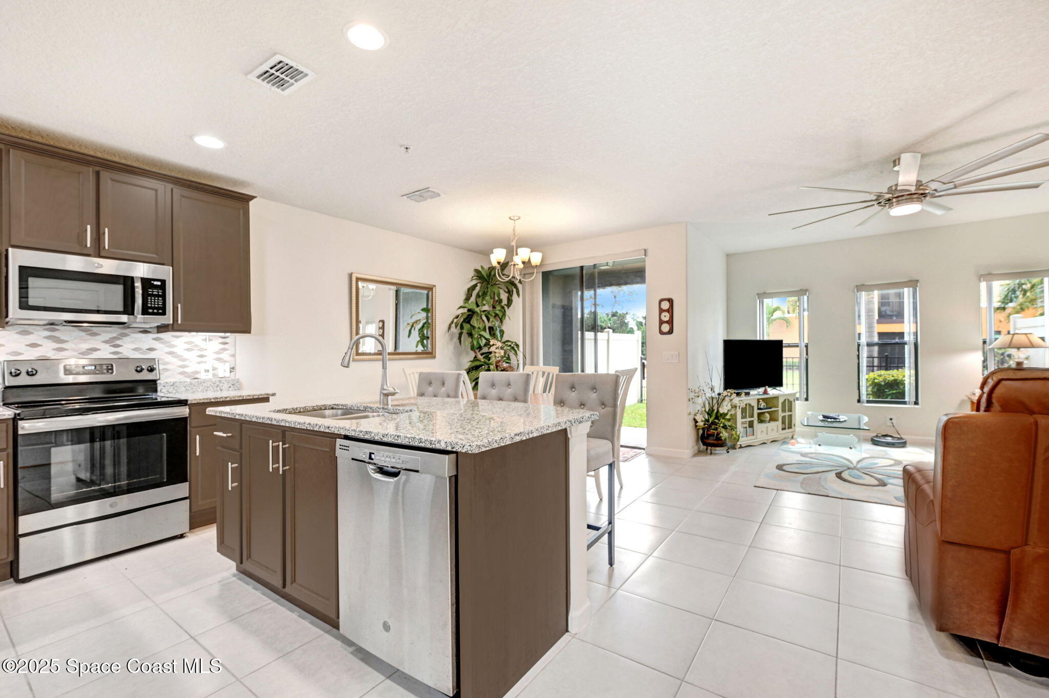 1430 Lara Circle, Unit 103 Rockledge, FL 32955 - Photo 12 of 39 a kitchen with stainless steel appliances granite countertop a stove and a sink