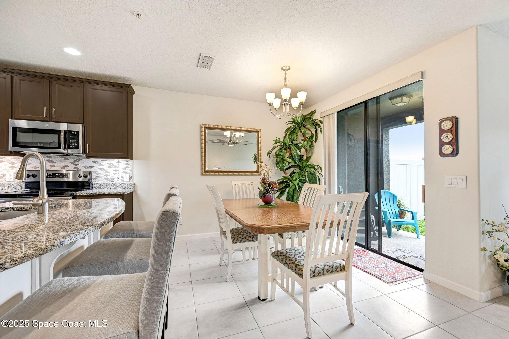 1430 Lara Circle, Unit 103 Rockledge, FL 32955 - Photo 13 of 39 a view of a dining room with furniture