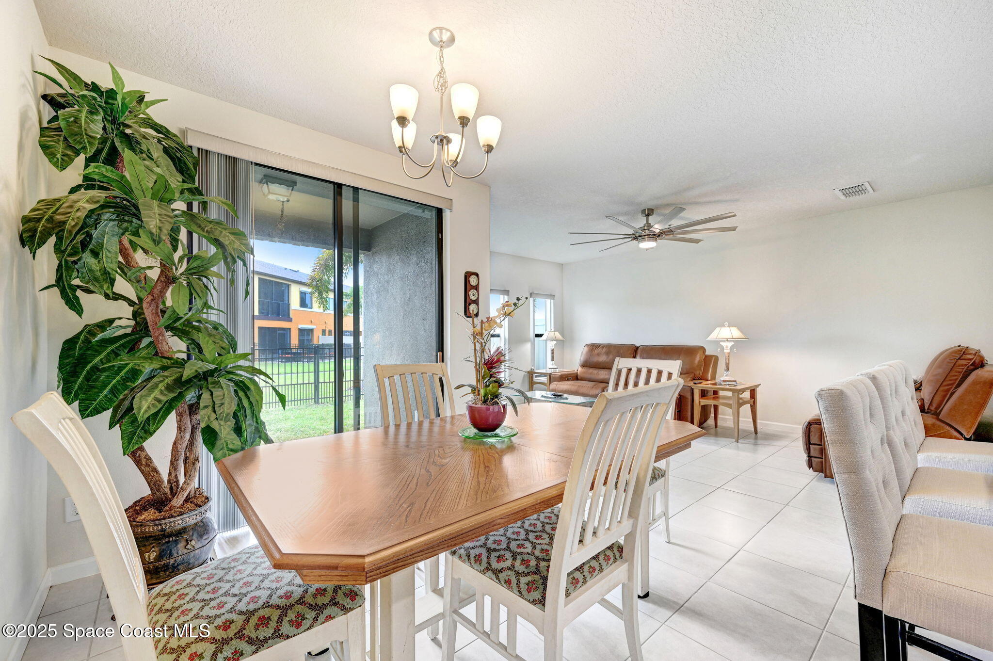 1430 Lara Circle, Unit 103 Rockledge, FL 32955 - Photo 14 of 39 a dining room with furniture a chandelier and wooden floor