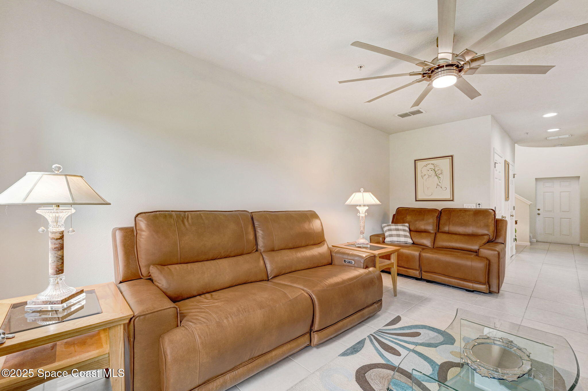 1430 Lara Circle, Unit 103 Rockledge, FL 32955 - Photo 16 of 39 a living room with furniture a bed and a chandelier