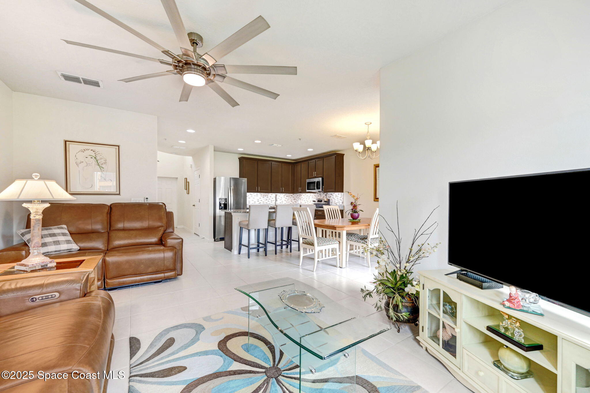 1430 Lara Circle, Unit 103 Rockledge, FL 32955 - Photo 17 of 39 a living room with furniture and a flat screen tv
