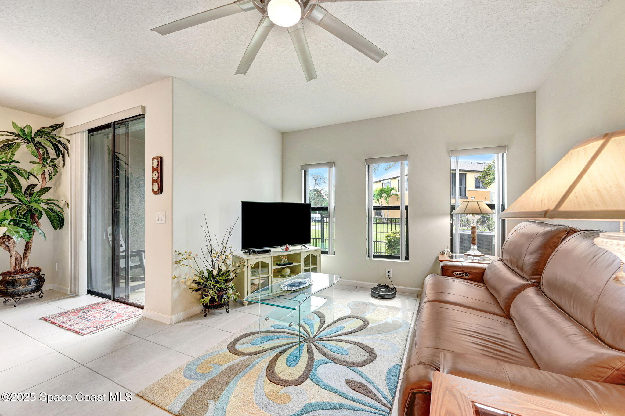 1430 Lara Circle, Unit 103 Rockledge, FL 32955 - Photo 18 of 39 a living room with furniture and a flat screen tv